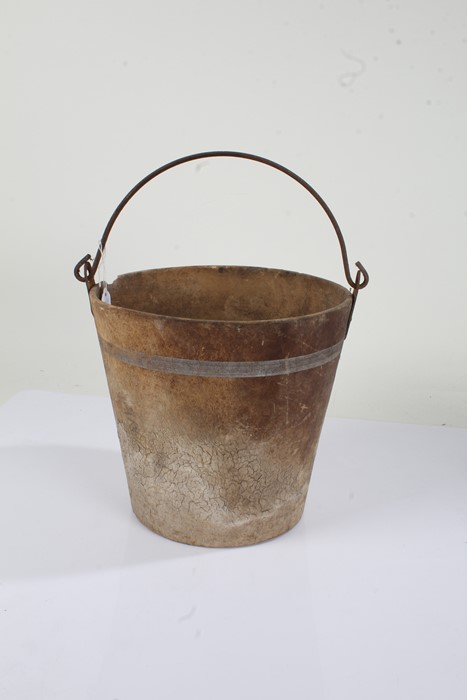 Bucket with steel swing handle above the leather tapering bucket, 28cm diameter, 26.5cm high