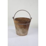 Bucket with steel swing handle above the leather tapering bucket, 28cm diameter, 26.5cm high
