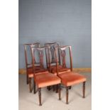 Set of four Edwardian mahogany dining chairs, with crested rails above pierced splats, the stuffed