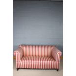 Late Victorian upholstered two seater settee, raised on turned legs, 173cm wide