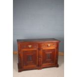 Late Victorian mahogany sideboard, fitted two drawers above a pair of doors with arts and crafts