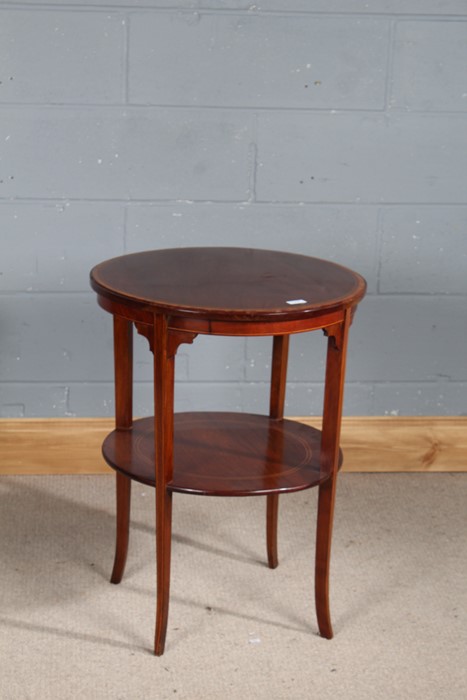Edwardian mahogany two tier table, the circular top with satinwood crossbanding above a second