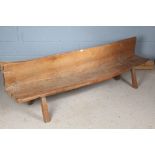 Indonesian primitive lightwood bench, the rectangular back above a rectangular top, raised on square