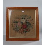 19th Century wool work panel, of flowers, housed within a maple frame, 56cm x 58cm including the