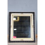 Ebonised, cream painted and gilded rectangular wall mirror, foliate carved outer, leaf and berry