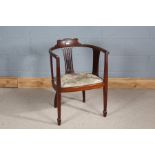 Edwardian mahogany tub chair, having shaped back rail, pierced slat backs and floral upholstery,