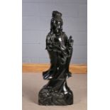 Substantial Chinese black hardstone figure, depicted holding a ruyi sceptre and a pearl, 94cm high