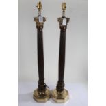 Pair of tall reeded mahogany and brass corinthian column capped column table lamps, on octagonal
