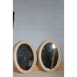 Pair of 19th Century oval bevelled wall mirrors with scumbled effect painted frames, 62cm x 89cm