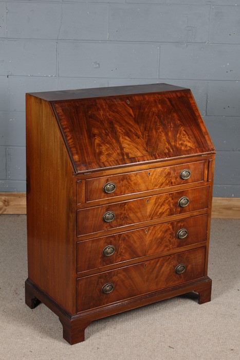 George III style mahogany bureau, the sloping fall enclosing a compartmentalised interior, fitted