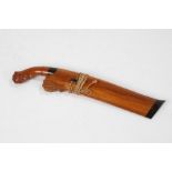 20th Century Sumatran sewer knife, with carved scrolled handle, steel blade and wooden sheath,