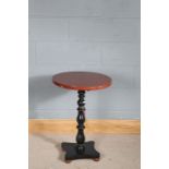 Circular simulated marble topped wine table, the red veined marble effect top on an ebonised