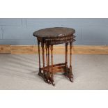Nest of three 20th century walnut occasional tables, with piecrust tops and bamboo style legs,