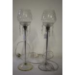 Pair of glass table lamps, the cut glass shades above prismatic drops and baluster stems, om domed