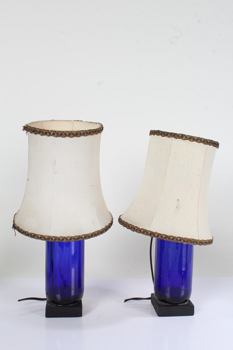 Pair of blue glass lamps, with black square bases, (2)