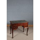 George III style mahogany writing desk, the shaped top with green leather insert, above five small