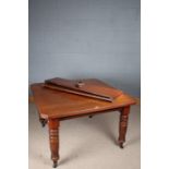 Victorian mahogany extending dining table, the rectangular top above turned legs with reeded