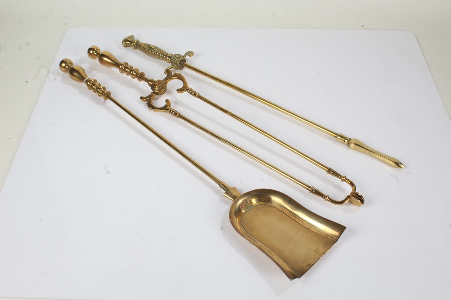 Three early 20th Century fireside tools, to include a heavy brass poker with engraved grip and guard