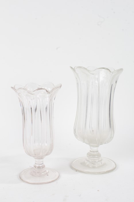 Two 19th Century glass vases, with bodies formed as tall leaves above the ring turned stem and wide,