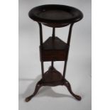 19th Century mahogany washstand, the circular top above a triangular middle tier fitted with two