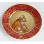 Dresden porcelain plate, centred with a religious figure within a gilt border on a maroon ground,
