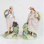 Pair of 19th Century Staffordshire figures, each holding baskets over their shoulders, on a