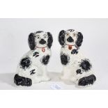 Pair of late 19th/ early 20th century Staffordshire spaniels, in black and white, 19.5cm high (2)