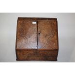 Large Victorian walnut stationery box, the sloping doors enclosing a compartmentalised interior, for