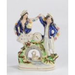 Victorian Staffordshire clock figure group, with figures either side of a clock face and a swan