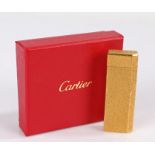 Cartier gold plated cigarette lighter, with mottled effect exterior, 7cm high, housed in a Cartier