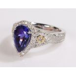 18 carat white gold tanzanite and diamond set ring, the central pear cut tanzanite at 3.54 carats