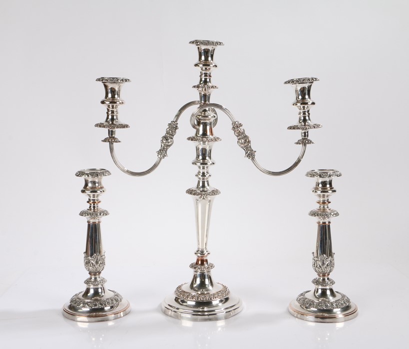 Sheffield plate candelabra, the three gadrooned sconces on reeded scrolling foliate cast stems, with