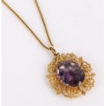 Victorian amethyst set pendant, on a yellow metal mount with scroll design together with a yellow