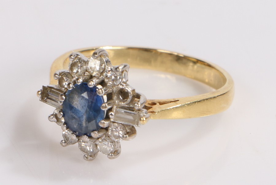 18 carat gold sapphire and diamond set ring, the central sapphire with round and baguette cut