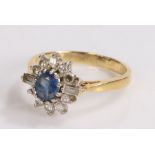 18 carat gold sapphire and diamond set ring, the central sapphire with round and baguette cut