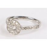 Platinum and diamond set ring, with a central diamond and diamond surround trailing down the