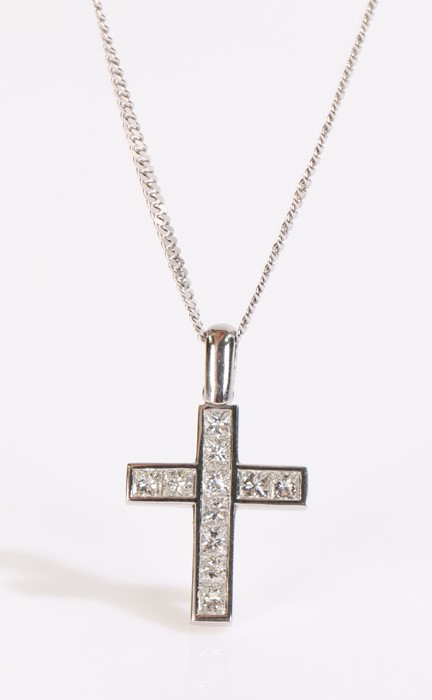 18 carat white gold diamond set cross, with eleven diamonds set to the cross and an attached 18