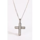 18 carat white gold diamond set cross, with eleven diamonds set to the cross and an attached 18