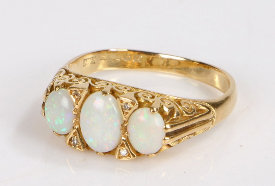 18 carat gold opal set ring, with three cabochon opals to the head, 5.9 grams, ring size Q