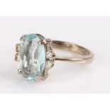 18 carat gold aquamarine set ring, with two pairs of diamonds either side, ring size F/G