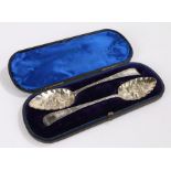 Pair of George III silver tablespoons with Victorian berry decorated bowls, housed in a fitted case,