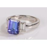 18 carat white gold tanzanite and diamond set ring, the central tanzanite at 2.71ct flanked by a