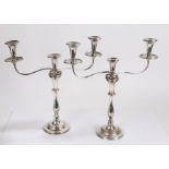 Pair of silver plated candelabra, with detachable triple sconces on scrolled supports, the waisted