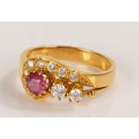 18 carat ruby and diamond set ring, with a central ruby and diamond swirl containing ten diamonds,