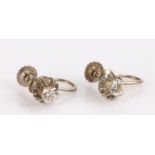 Pair of 9 carat white gold diamond set earrings, with a round cut diamond to each head, the diamonds