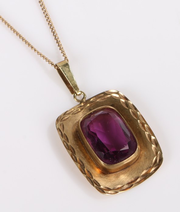 9 carat gold amethyst set pendant necklace, with a emerald cut amethyst to the arched gold panel,