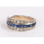 18 carat gold sapphire and diamond set ring, the row of sapphires flanked by diamonds either side,