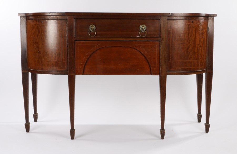 19th Century mahogany and crossbanded sideboard, the rectangular top with bowed corners above two