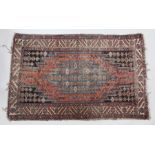 Moslaghan rug, the stepped tomato red field with blue coloured medallion within typical indigo