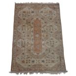 Turkish Khula carpet, the cream ground with scroll and foliate decoration, with tasselled ends,